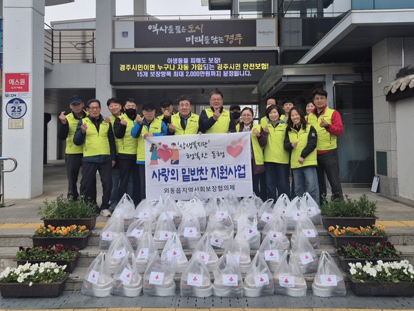 외동읍 지역사회보장협의체 위원들이 취약계층 44가구에 전달할 밑반찬을 마련한 뒤 기념촬영을 하고 있다.[경주시 제공]